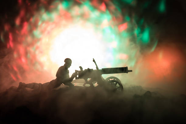 istock Man with Machine gun at night, fire explosion background or Military silhouettes fighting scene on war fog sky background, World War Soldiers Silhouettes Below Cloudy Skyline At night. 941121686