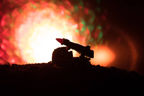 istock Rocket launch with fire clouds. Battle scene with rocket Missiles with Warhead Aimed at Gloomy Sky at night. Rocket vehicle on War Backgound. 941121738