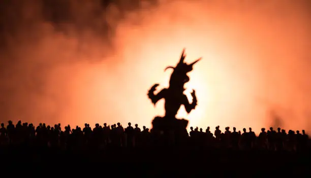 Blurred silhouette of giant monster prepare attack crowd during night. Selective focus.