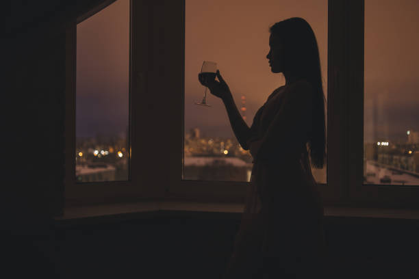 istock Silhouette of woman in window 941121844