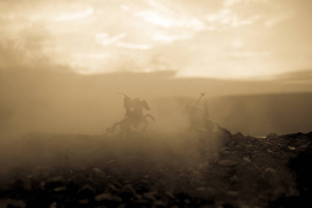 istock Joust between two knights on horseback. Sunset on background. Selective focus 941121854