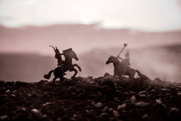 istock Joust between two knights on horseback. Sunset on background. Selective focus 941121874