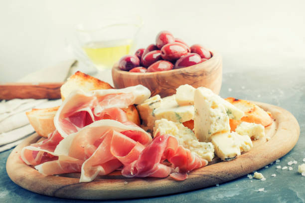 istock Snacks or antipasti, crostini, prosciutto, blue cheese and olives 941122096