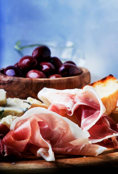 istock Snacks or antipasti, crostini, prosciutto, blue cheese and olives 941124880