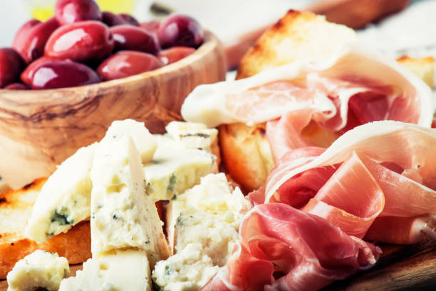 istock Snacks or antipasti, crostini, prosciutto, blue cheese and olives 941125124