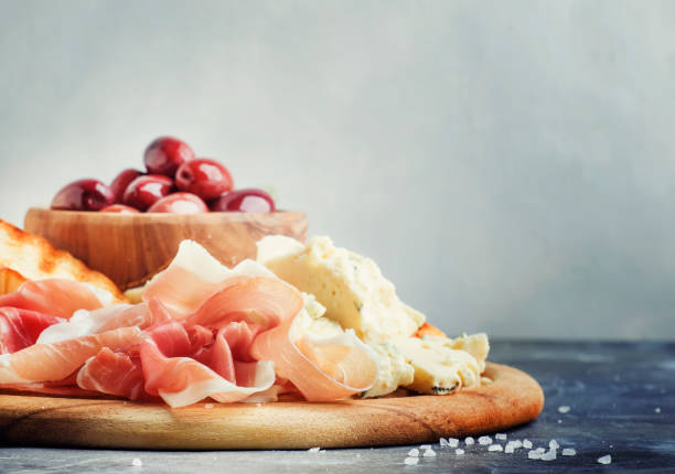 istock Snacks or antipasti, crostini, prosciutto, blue cheese and olives 941125236