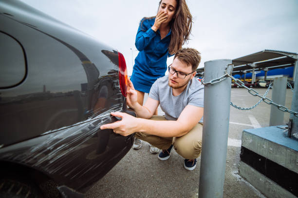 man with sad look on scratched car. woman with sorry look near d - dented imagens e fotografias de stock