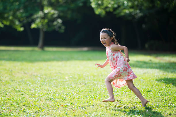 istock Little girls playing on the lawn 941133436