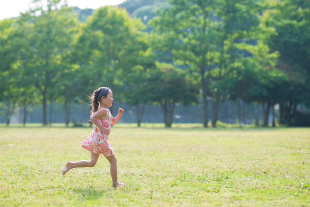 istock Little girls playing on the lawn 941133472