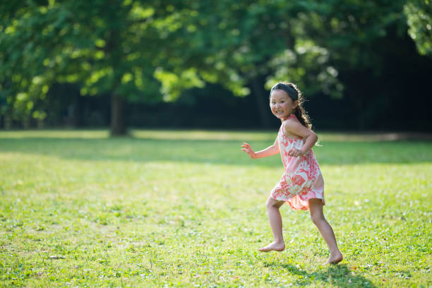 istock Little girls playing on the lawn 941133826