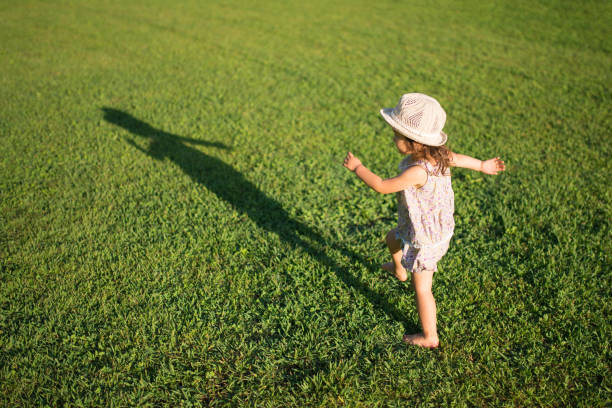 istock Little girls playing on the lawn 941137180