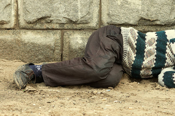 istock homeless man sleeping on the street 94113740