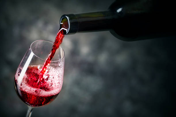 Red wine is being poured into glass