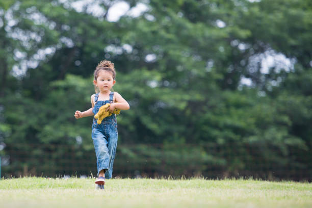 istock Little girl playing with a teddy bear 941143042