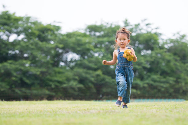 istock Little girl playing with a teddy bear 941143168