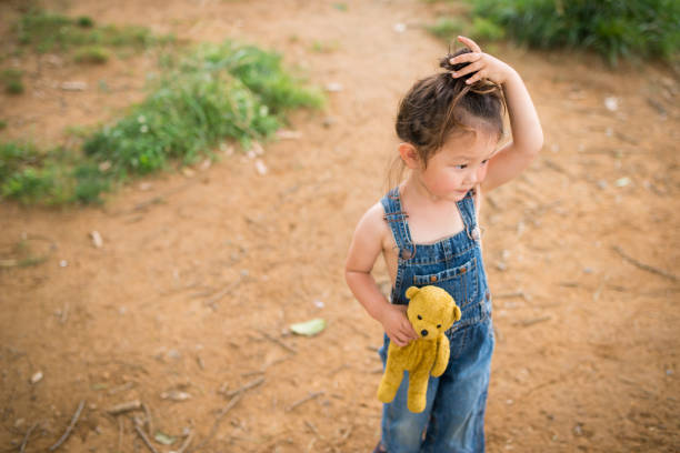 istock Little girl playing with a teddy bear 941143340