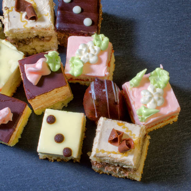 istock Assorted colorful natural sweet cakes on a black background. Copy space for text.  Concept of tasty cakes. Food background. 941152354