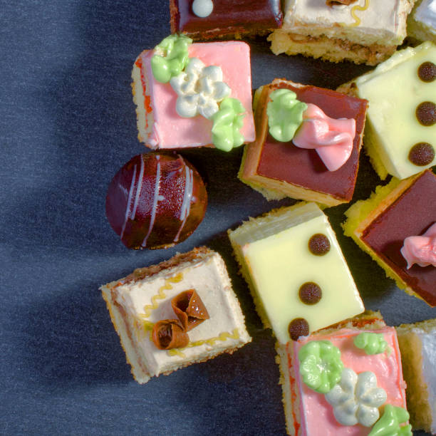 istock Assorted colorful natural sweet cakes on a black background. Copy space for text.  Concept of tasty cakes. Food background. Top view. 941152720