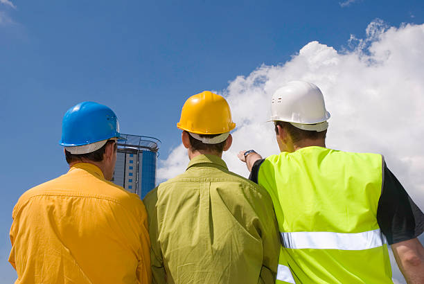 istock The backs of three builders in uniform 94115824