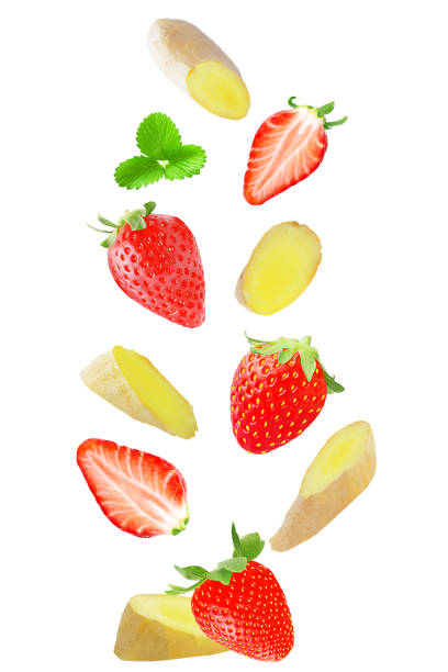 istock Isolated falling strawberry and ginger on white background with clipping path as package design element and advertising 941160198