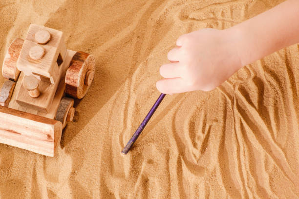 istock Toddler playing with wooden toy tractor bulldozer 941165954