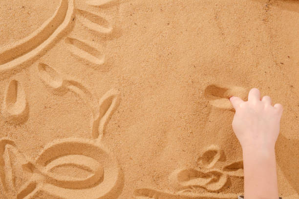 istock Sand therapy, child's hands are painted on table with sand 941166026