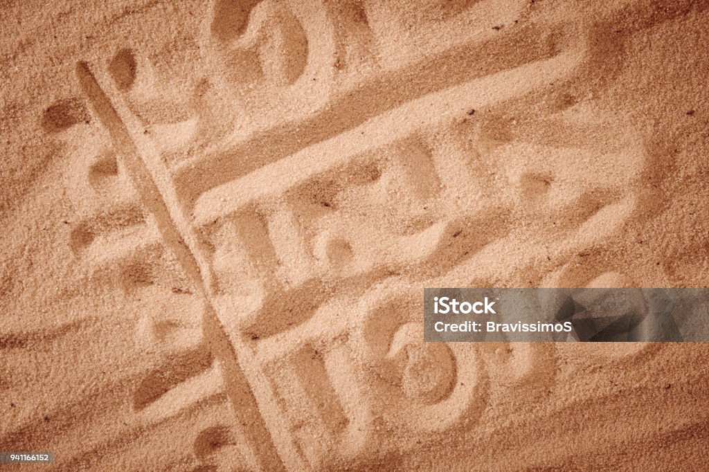 tic-tac-toe drawing in sand background tic-tac-toe drawing in sand background. Game on a beach Beach Stock Photo