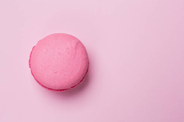 istock pink makroon on a pink background, stylish image, concept 941167386