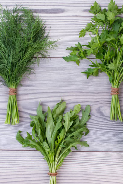 istock Mixed green herbs on wooden background. 941167444