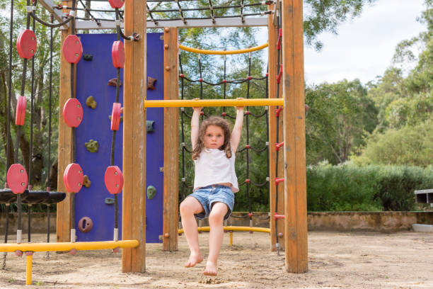 istock Little girl on playground equipment in bush setting 941171320