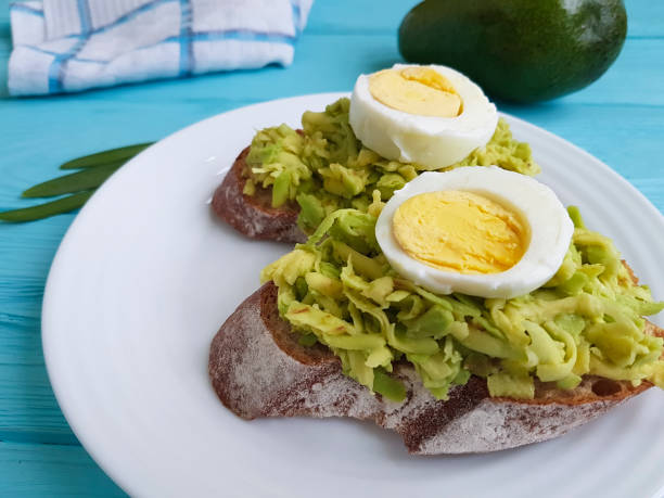 sandwich with avocado egg on blue wooden