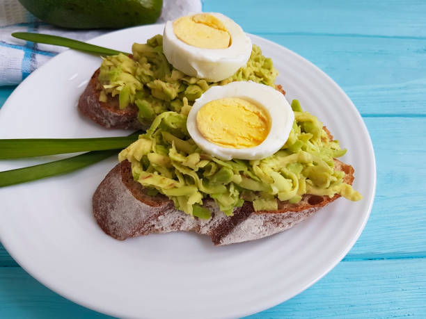sandwich with avocado egg on blue wooden