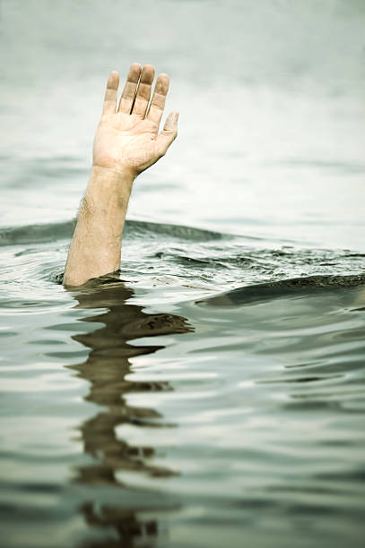 istock A man drowning in a lake with his arm reaching up 94117507