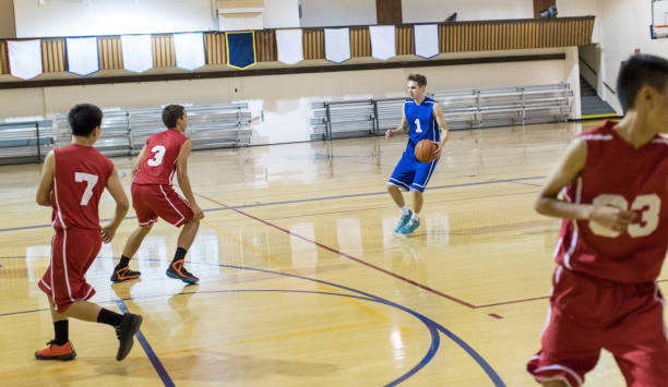 istock Teenage basketball player pulls up behind the three-point line to shoot! 941175668