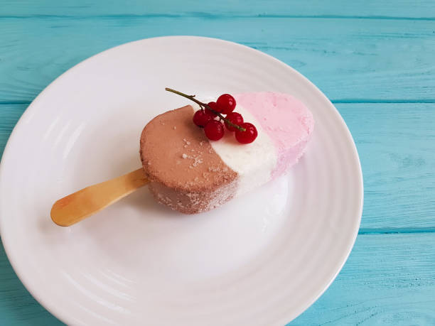 istock ice cream with red currant on blue wooden 941178086