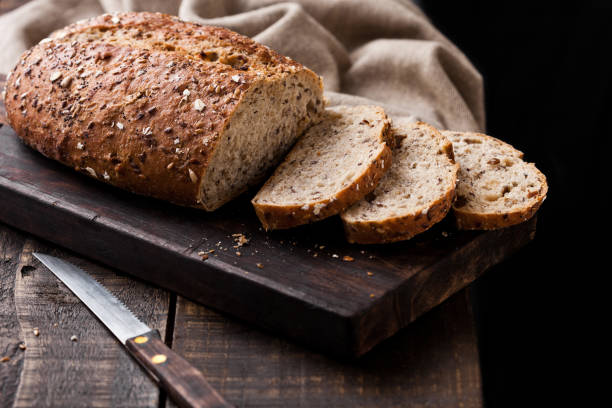 istock Freshly baked  bread with kitchen towel and knife 941180946