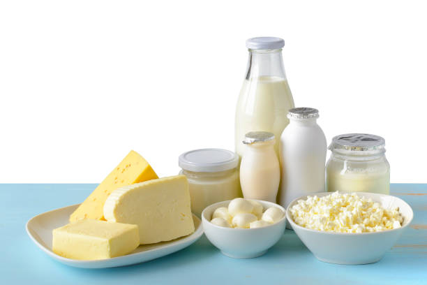 istock Dairy products on blue wooden table isolated on white. 941184314