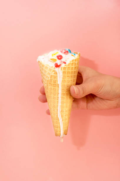 istock Hand holds ice cream that melts and drips in a waffle cone 941187282
