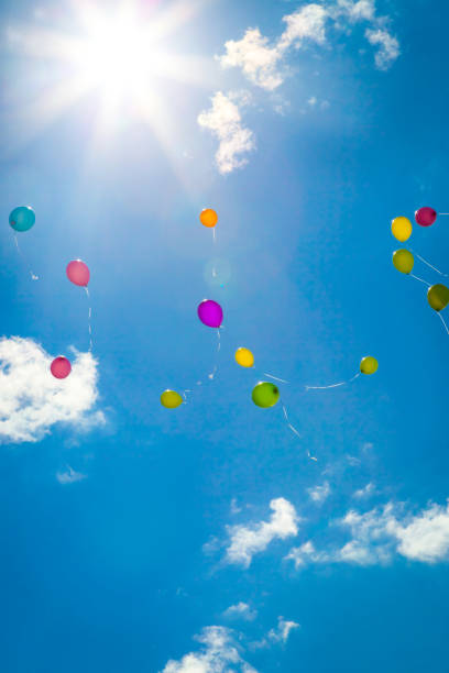 istock Colored flying balloons in the blue sky 941187640