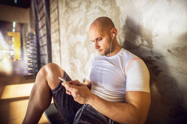 Young Muscular Shape Strong Bald Man Relaxing And Resting With
