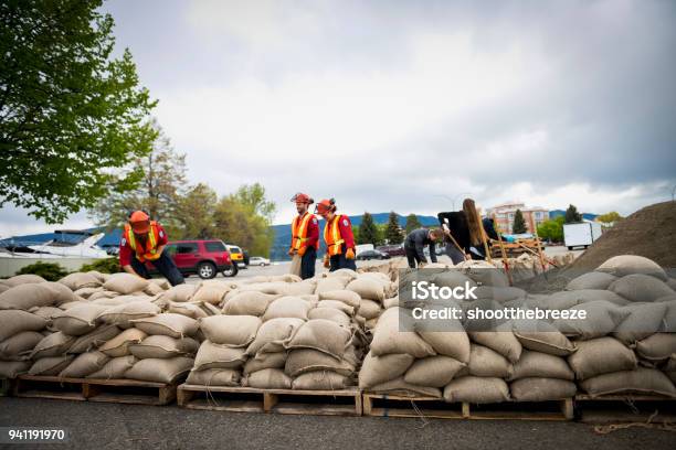 Sandbag Building For Flooding In The Okanagan Stock Photo - Download Image Now - Emergency Planning, Flood, Accidents and Disasters