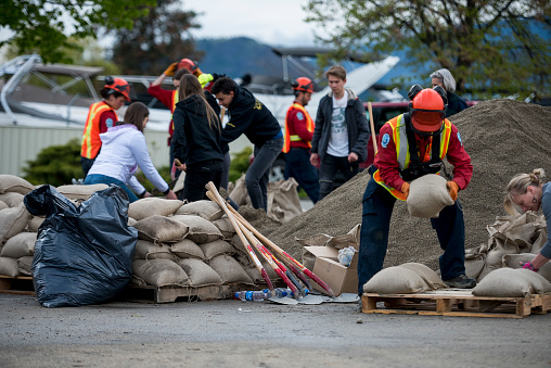 KELOWNA, CANADA - MAY 12: An emergency response worker piles sandbags on a pallette on May 12, 2017 in Kelowna, British Columbia, Canada.