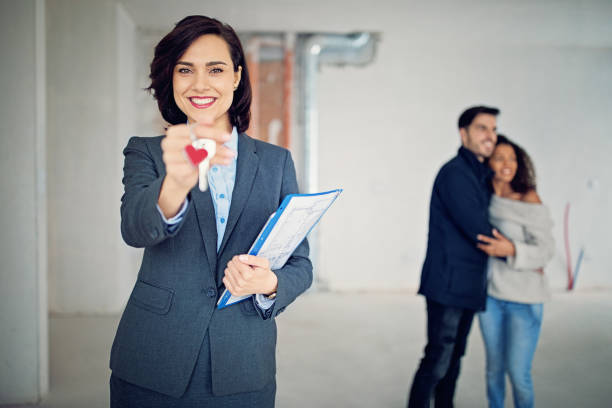 istock Real estate agent is holding key for a new apartment 941192138