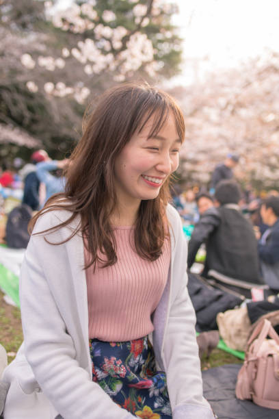 istock Young woman smiling in Hanami party 941193264