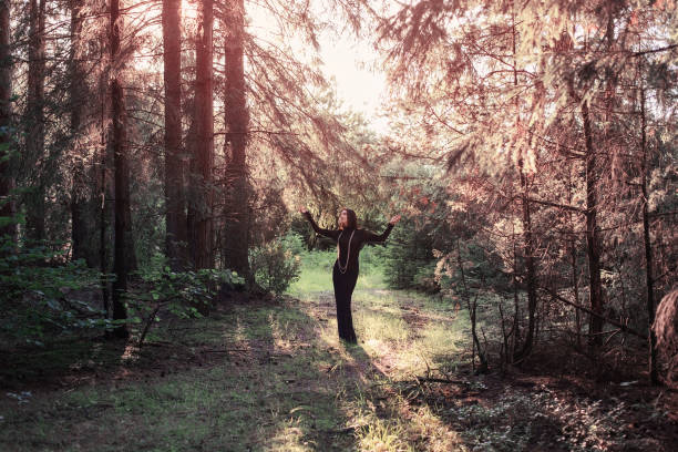 istock Beautiful witch posing in a mystic forest 941194744