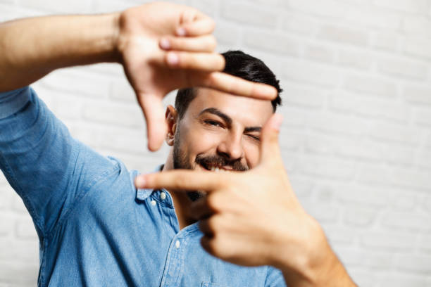Facial Expressions Of Young Beard Man On Brick Wall