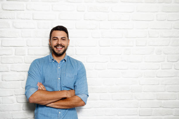 istock Facial Expressions Of Young Beard Man On Brick Wall 941198284