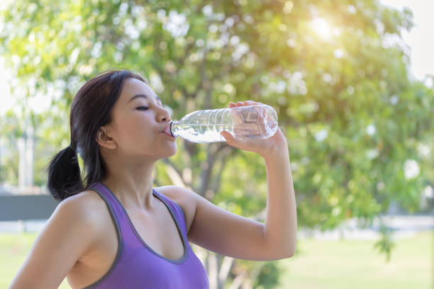 istock Women drinking water after exercise. 941217160