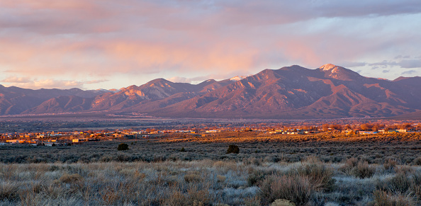 Taos Valley, New Mexico at sunset viewed from Llano, with Sangre de Cristo Mountains in the background