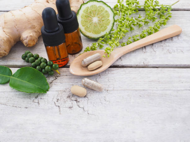 istock herbal pills in wooden spoon 941217410